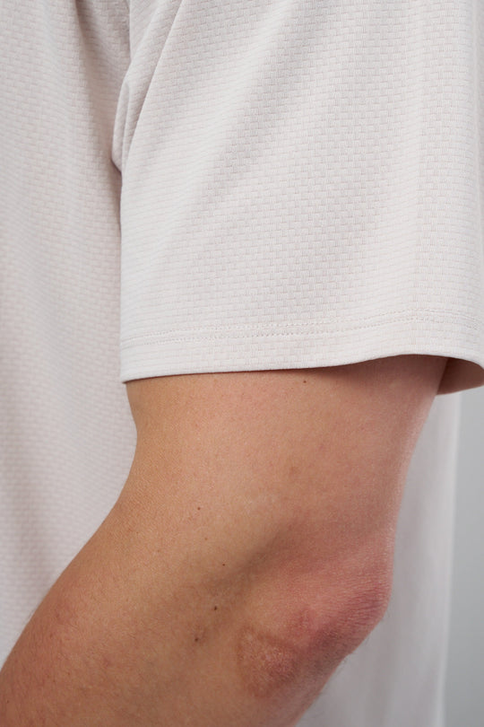 Performance tee with raglan sleeves designed for freedom of movement and all-day comfort.